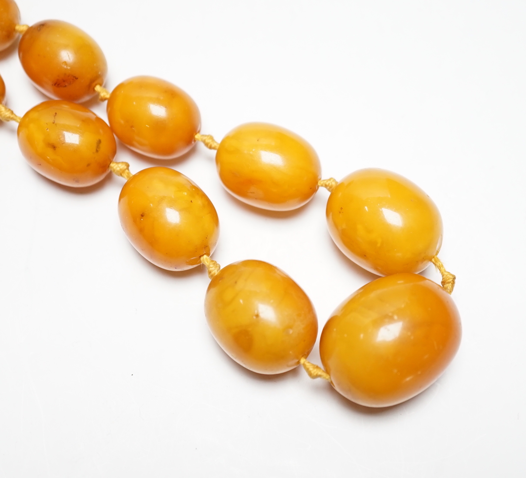 A single strand graduated oval amber bead necklace, 50cm, gross weight 81 grams.